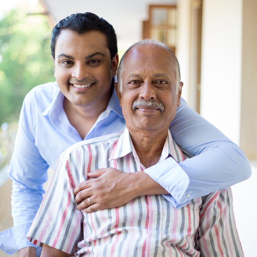 man with arm around his senior father