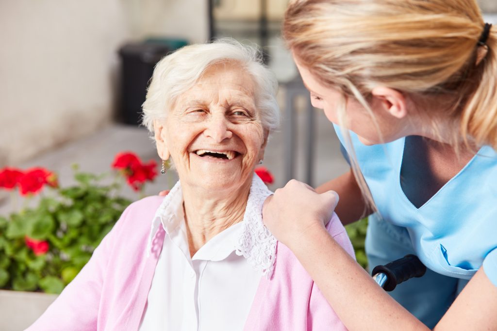health professional woman attending to a smiling senior woman